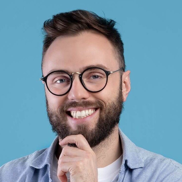 happy young man with book looking at camera and sm 2022 12 16 06 37 14 utc cropped.jpg